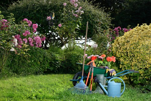 Operatives using appropriate PPE while working in a garden